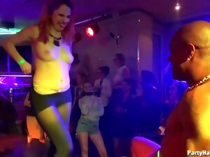 Kinky Ladies Are Teasing A Guy Who Is Tied Up On The Stage, In The Night Club